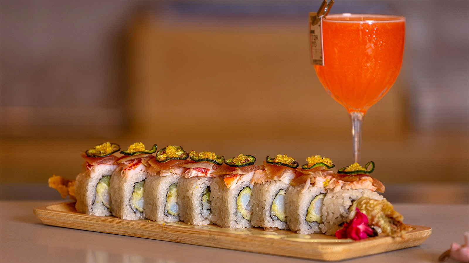 A 401K cocktail next to a decorated sushi roll at Aya Sushi
